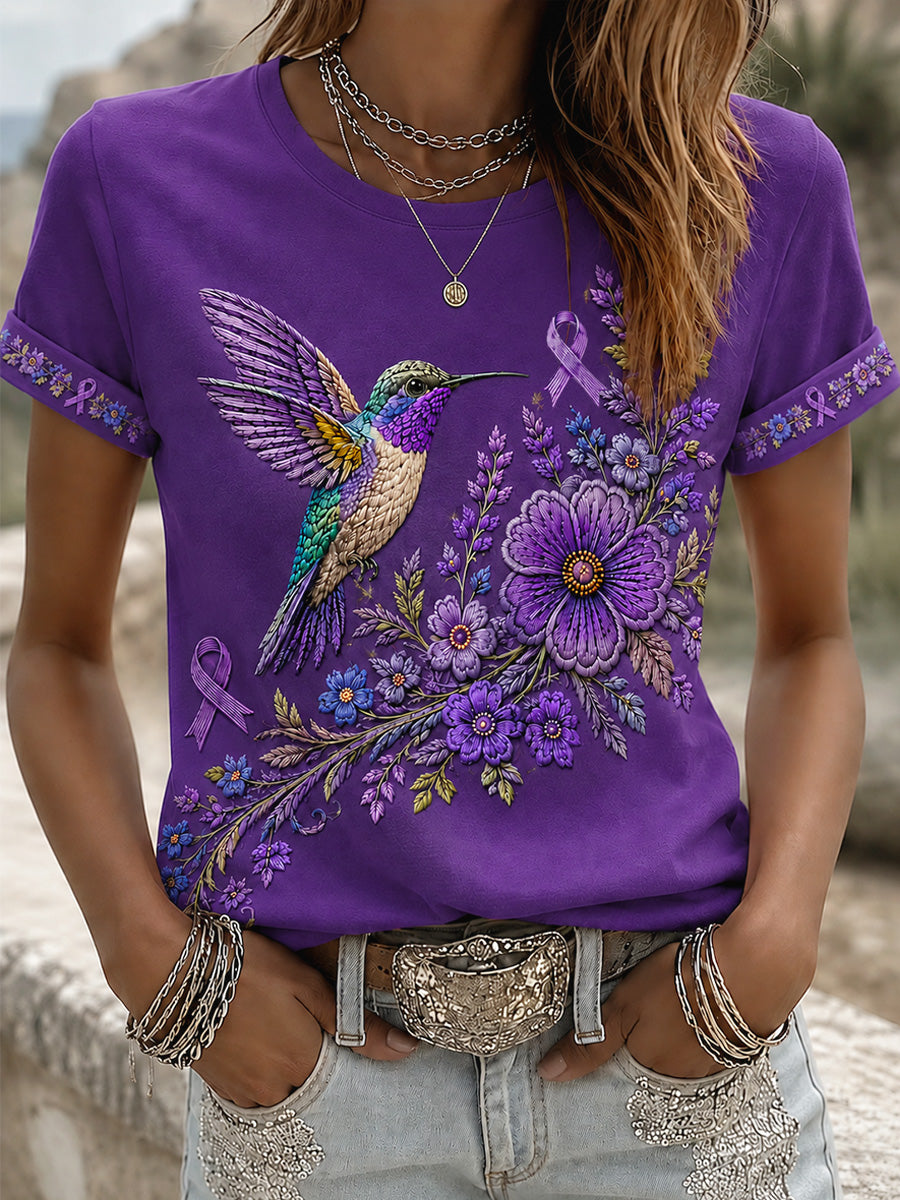 Dame-T-shirt med lilla blomster- og kolibriprint til støtte for alzheimers-ophid­sels­es­kam­pa­gnen