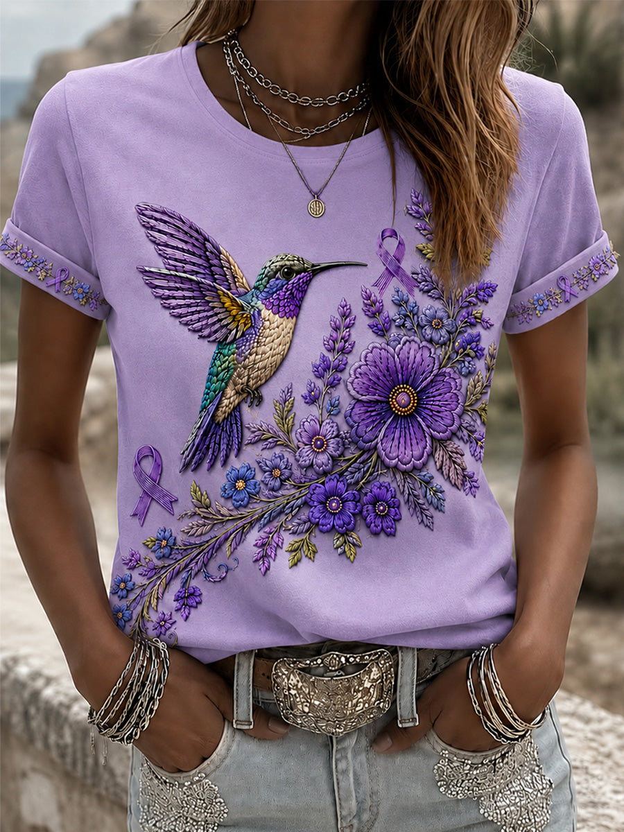 Dame-T-shirt med lilla blomster- og kolibriprint til støtte for alzheimers-ophid­sels­es­kam­pa­gnen