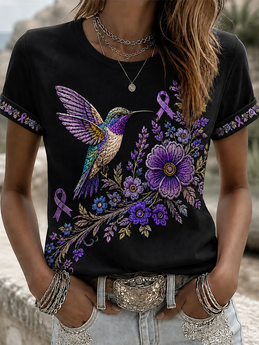 Dame-T-shirt med lilla blomster- og kolibriprint til støtte for alzheimers-ophid­sels­es­kam­pa­gnen