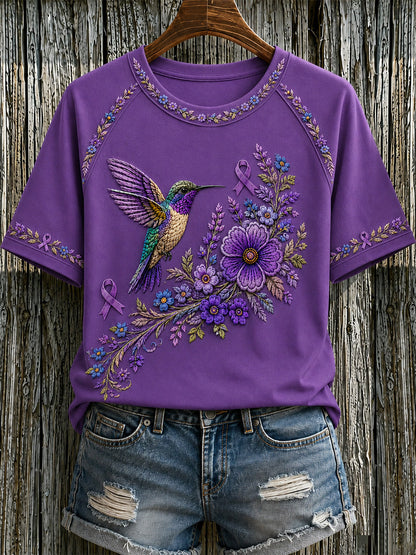Dame-T-shirt med lilla blomster- og kolibriprint til støtte for alzheimers-ophid­sels­es­kam­pa­gnen