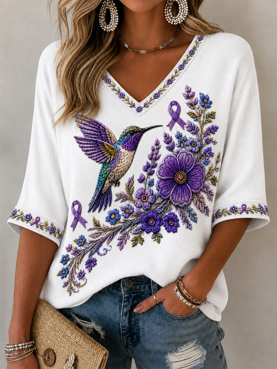 Dame-T-shirt med lilla blomster- og kolibri-print til støtte for alzheimers-håndteringen, med V‑udskæring