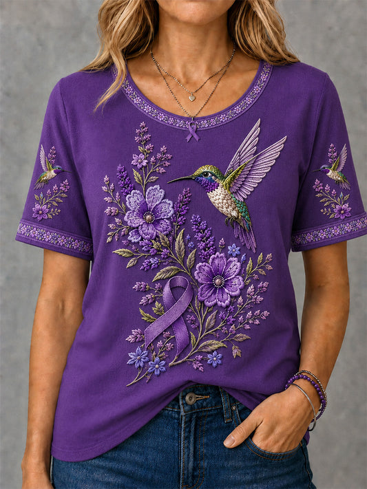Dame-T-shirt med lilla blomster- og kolibriprint til støtte for alzheimers-ophid­sels­es­kam­pa­gnen
