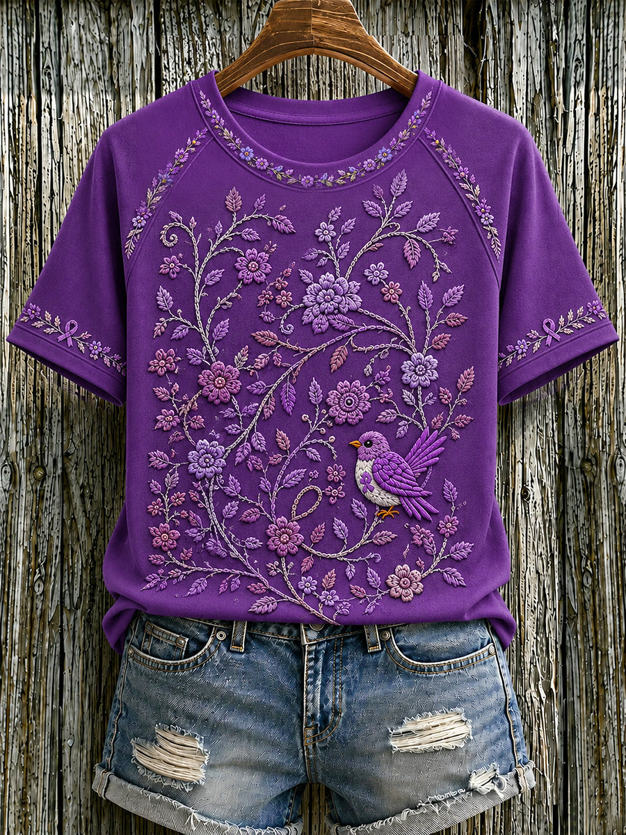 Dame-T-shirt med lilla blomster- og kolibriprint til støtte for alzheimers-ophid­sels­es­kam­pa­gnen