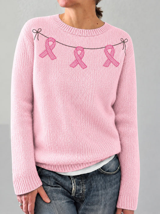 Kvinders elegante, behagelige sweater med lyserødt båndprint