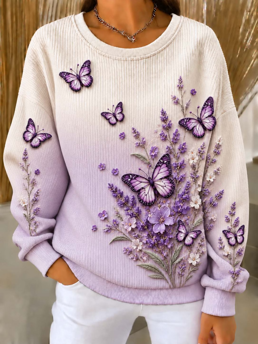 Damebluse med sommerfugle- og blomsterprint, ribstrikket og rund hals
