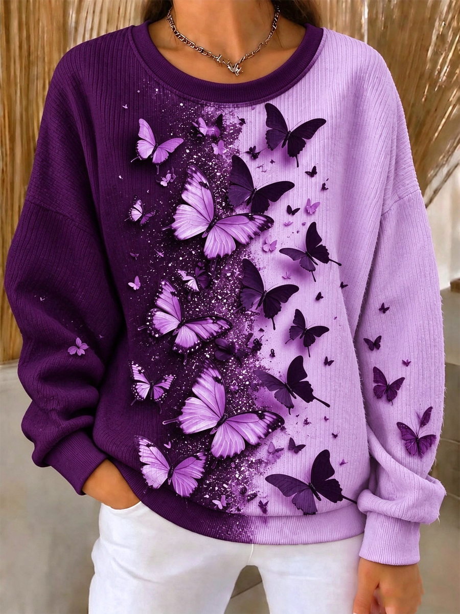 Damebluse med butterflyprint, ribstrikket og rund hals